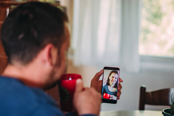 istock Person doing a video chat with mobile phone at home 1221043014