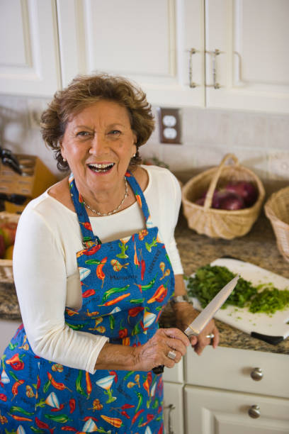 istock Senior woman in the kitchen smiling 1221045720