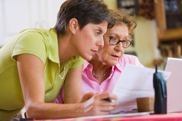 istock Mother and daughter in front of laptop computer in the kitchen 1221045850