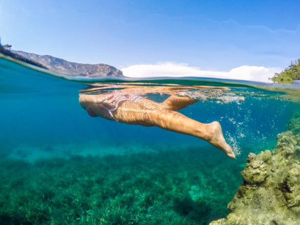 istock Woman floating in the clean sea. 1221046321
