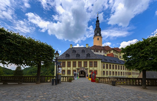 Weesenstein, Germany (State Saxony), May 26, 2018: The castle was erected sometime around 1200. The oldest part of the presently visible castle is its central round tower, built sometime around 1300. The castle is a mix of styles, ranging from Gothic architecture to Classical architecture. Numerous works of art were kept here at the end of the Second World War and were thus saved from the bombs.