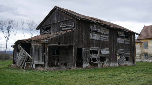 istock an old wooden hut on a field 1221048919