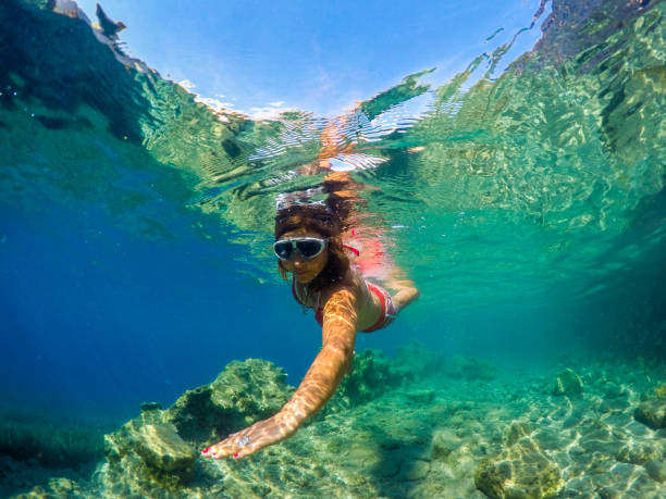 istock Woman floating in the clean sea. 1221049279
