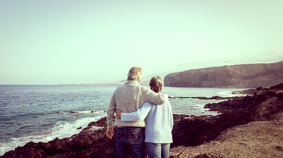 Happy retired couple senior in love enjoying seascape in the morning. Retirement concept two caucasian people