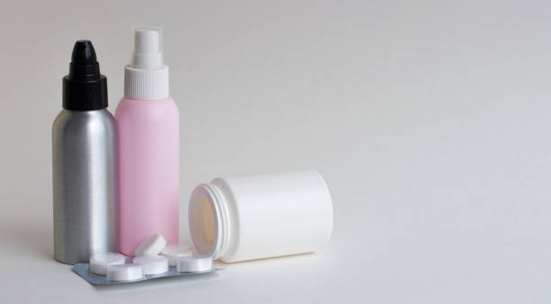 istock Bottles with tablets in white, pink, gray on a gray background. Copy space 1221052184