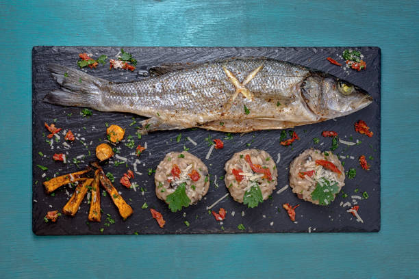 istock Fish with mushroom rizotto black 1221052694