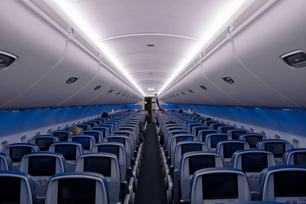 Empty seats on flight during COVID-19 pandemic Atlanta, USA - March 21, 2020: Delta Airlines flight 0958, from Atlanta to Melbourne, FL, prepares to depart with only a handful of passengers on board due to the spreading coronavirus pandemic. delta stock pictures, royalty-free photos & images