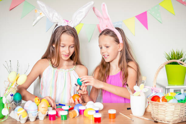 istock Happy easter. Beautiful little kids wearing bunny ears on Easter day. 1221055229