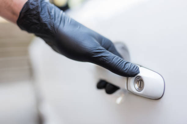 istock Driver with surgical protective gloves opening car door. Coronavirus prevention. 1221055374