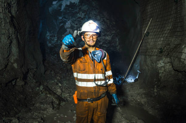istock Miner in the mine. Well-uniformed miner inside mine raising thumb 1221055720