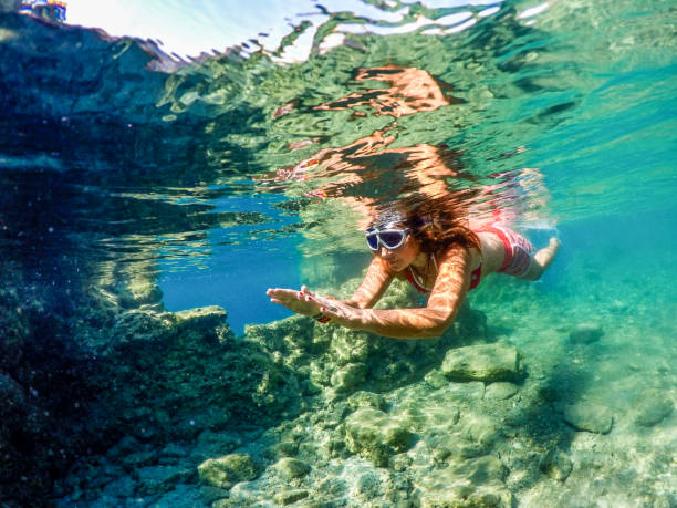 istock Woman floating in the clean sea. 1221055786