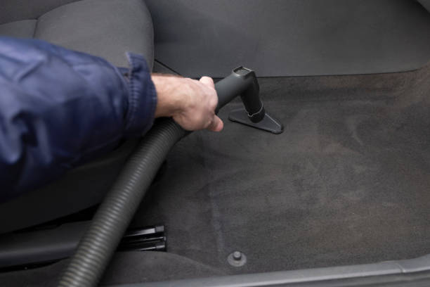istock A man is vacuuming a car interior. 1221056803