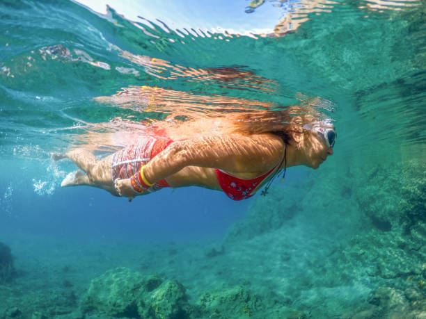 istock Woman floating in the clean sea. 1221056859