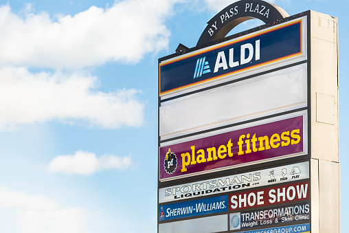 Beckley, USA - October 17, 2019: City during day with closeup of Strip Mall sign called Bypass plaza with Aldi store and planet fitness