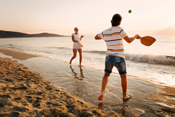 istock Friends playing beach tennis 1221057111