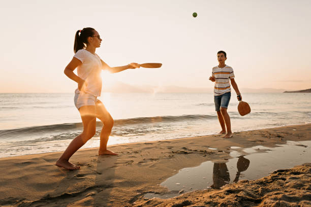 istock Friends playing beach tennis 1221057156