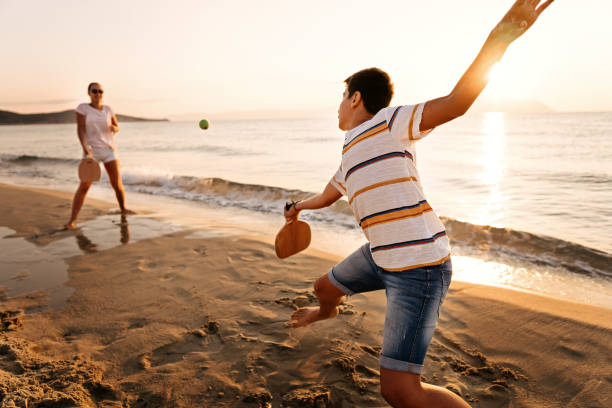 istock Friends playing beach tennis 1221057203