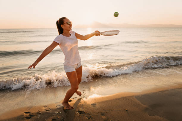 istock Girl playing beach tennis 1221057976