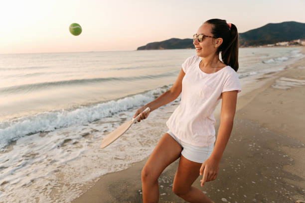 istock Girl playing beach tennis 1221058019