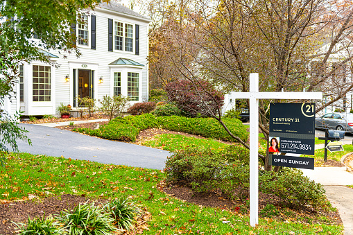 Herndon, USA - November 10, 2019: Open house sunday real estate home buyer sign in front of house driveway street in Fairfax County, Virginia neighborhood Century 21 agent