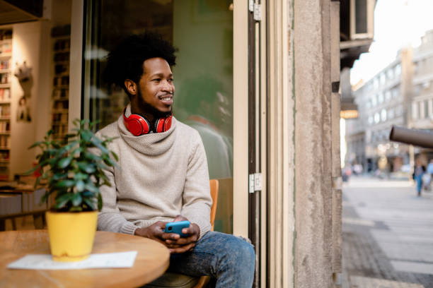 istock Young Afro American man sitting in a cafe 1221058296