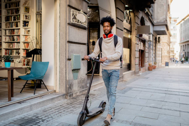istock Young African American man with an electric scooter 1221058359