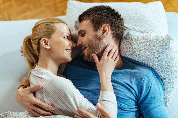 istock Happy couple in love lying embraced in bed. 1221058658