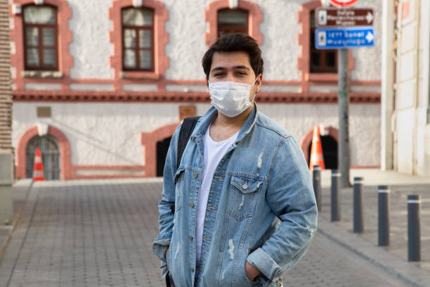 istock Young man is walking on the street with a protective mask 1221059808