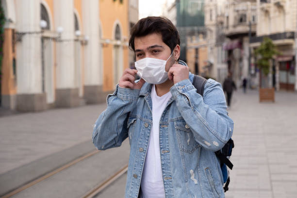 istock Young man is walking on the street with a protective mask 1221059832