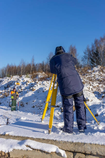 istock Surveyor with an assistant do a geodetic survey at a construction site 1221059944