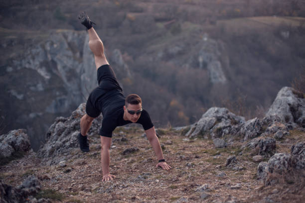istock Young man stretching after a run on mountain 1221060127