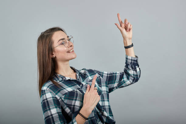 istock happy woman with glasses smiles, gestures with her hands 1221061308