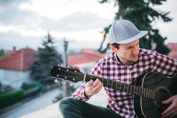 istock Young man playing the guitar at terrace 1221063285