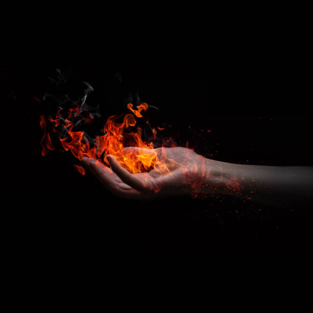 istock Flame in a woman's hand isolated on black background 1221063638