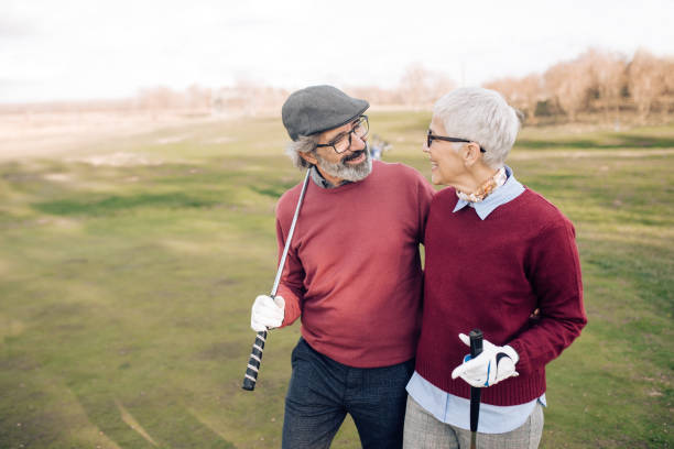 istock Happy senior couple enjoying playing golf 1221063716