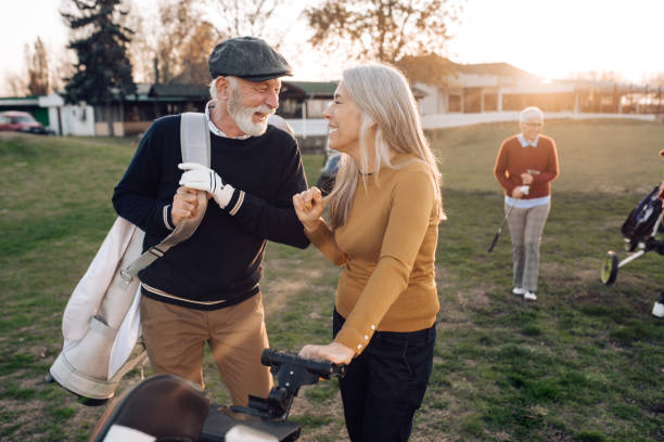 istock Senior couple going to play golf with close friends 1221063797