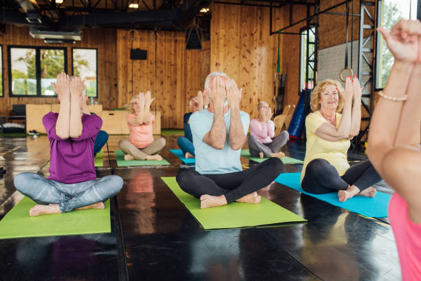 istock Seniors doing easy yoga in group 1221063894