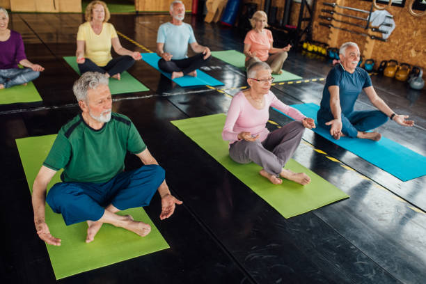 istock Group of seniors practicing breathing on the yoga class 1221063901
