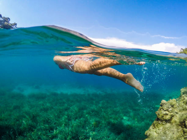 istock Woman floating in the clean sea. 1221064525
