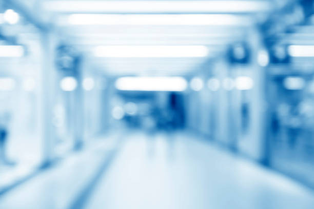 istock Abstract blurred interior of corridor clinic background in blue color , blurry image 1221064604