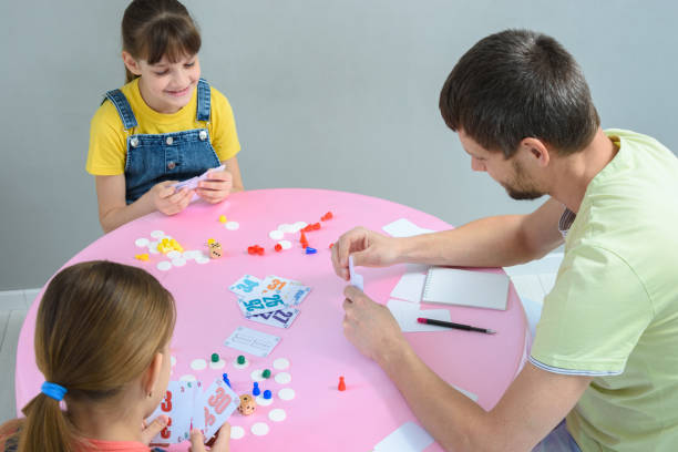 istock Family plays board games at the table, top view 1221064706