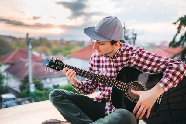 istock Young man playing the guitar at terrace 1221064809