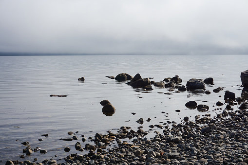 LAKE SHORE, WITH STILL WATERS, STONES ON THE COAST, CLOUDY SKY, LAKE NAHUEL HUAPI, CITY OF BARILOCHE, PROVINCE OF RIO NEGRO, ARGENTINA, LANDSCAPES OF PATAGONIA