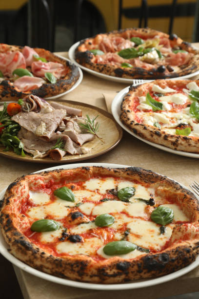 istock five hot an delicious italian pizza on table 1221066005