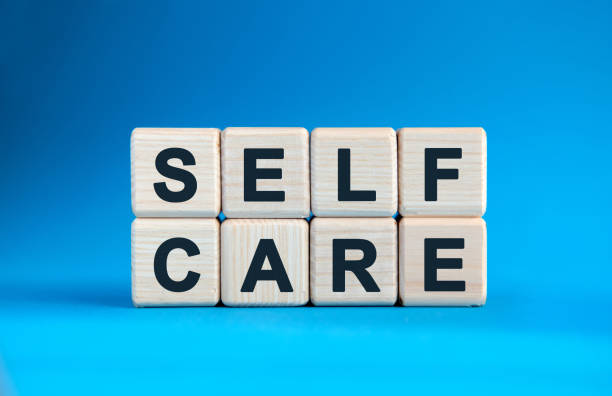 istock SELF CARE - text on wooden cubes on a blue gradient background 1221066913