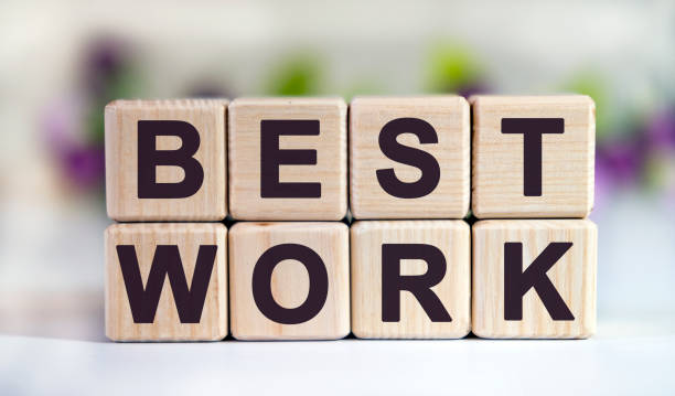 istock BEST WORK - text on wooden cubes on a floral background with tulip buds 1221066915