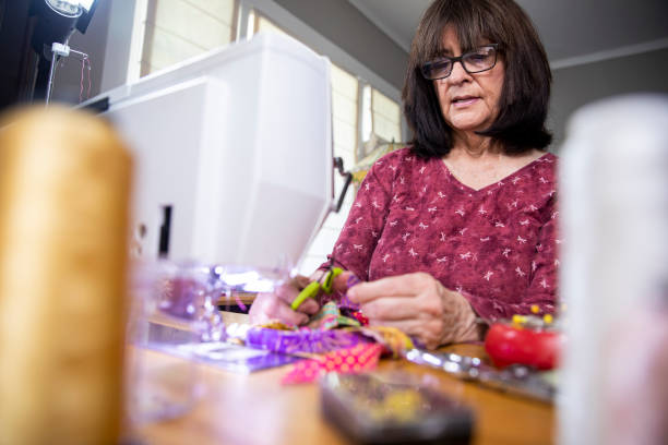 istock Woman Sewing Face Masks during Coronavirus Pandemic 1221066980