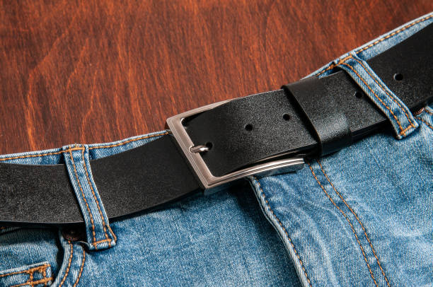 istock Denim pants in blue on a wooden background 1221067733