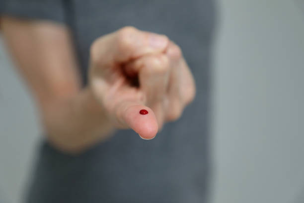 Finger prick blood test stock photo