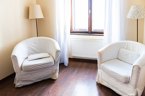 Chairs two armchairs and lamps in house or apartment with simple minimalism by curtains drapes of window and nobody in room